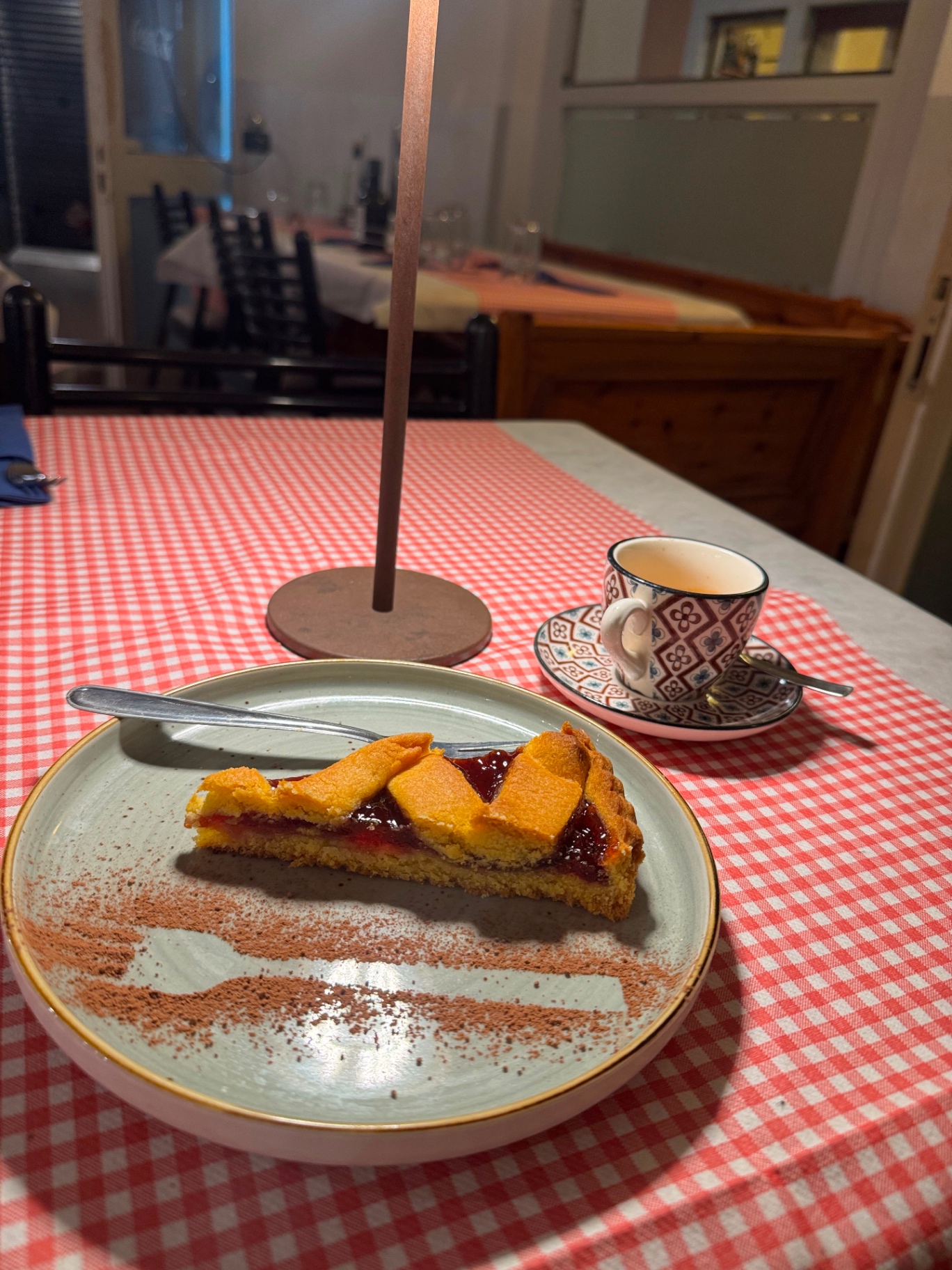 The pleasure of not getting up just yet: A slice of jam tart, a coffee, five more minutes at the table. The simplest moment in a trattoria — and often the best.